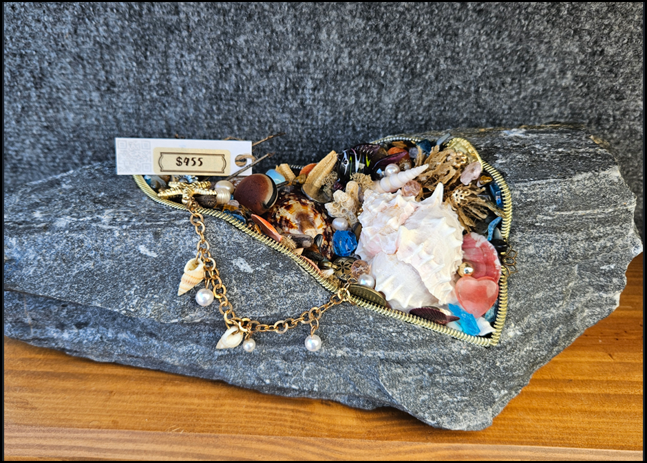 A heart shaped necklace with shells and pearls
AI-generated content may be incorrect.